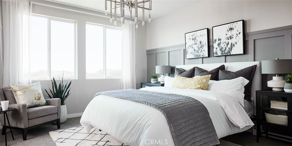 11541 Jack Street Beaumont, CA 92223 - Photo 11 of 11 a spacious bedroom with a bed a couch and a window