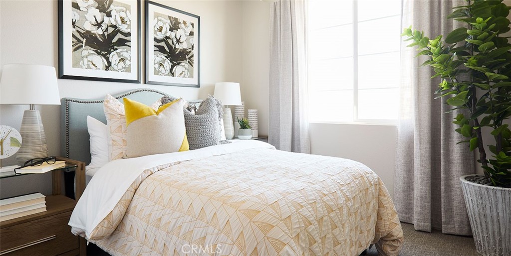 11541 Jack Street Beaumont, CA 92223 - Photo 4 of 11 a large bed sitting in a bedroom next to a window