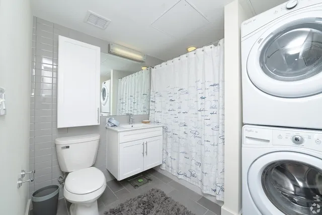 a bathroom with a sink a toilet and a mirror