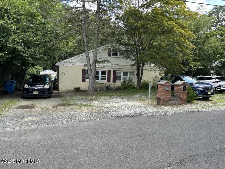 a car parked in front of a white house