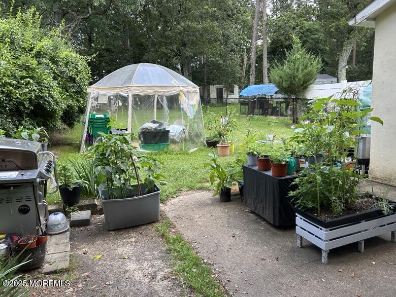 401-403 Glenn Road Jackson, NJ 08527 - Photo 5 of 8 a view of a garden with furniture and a garden