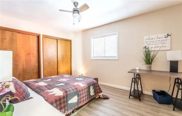 a bed sitting in a bedroom next to a window