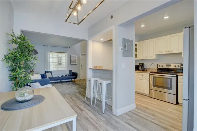 a kitchen with sink refrigerator and stove