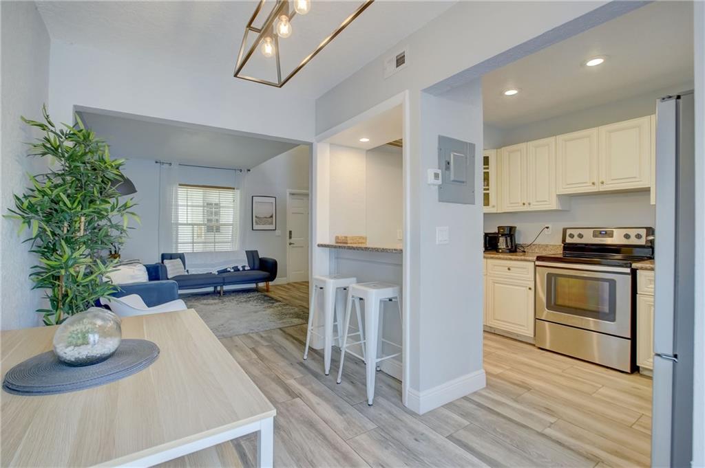 a kitchen with sink refrigerator and stove