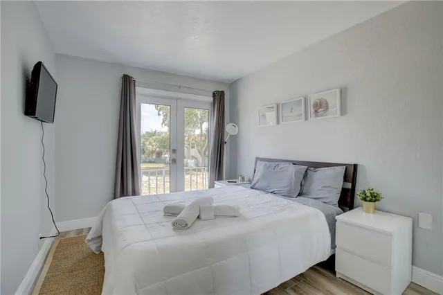 a bed sitting in a bedroom next to a window