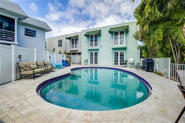 a swimming pool with outdoor seating and yard