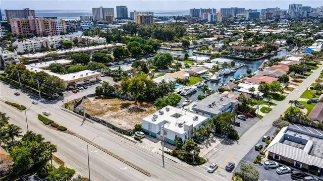 an aerial view of residential houses with city view