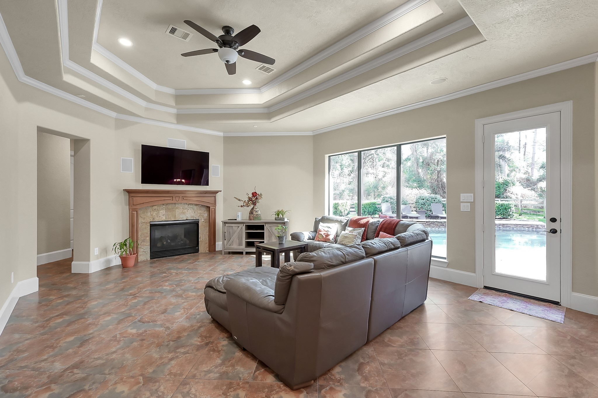22742 Timberlake Creek Road Tomball, TX 77377 - Photo 24 of 50 a living room with furniture a fireplace and a flat screen tv