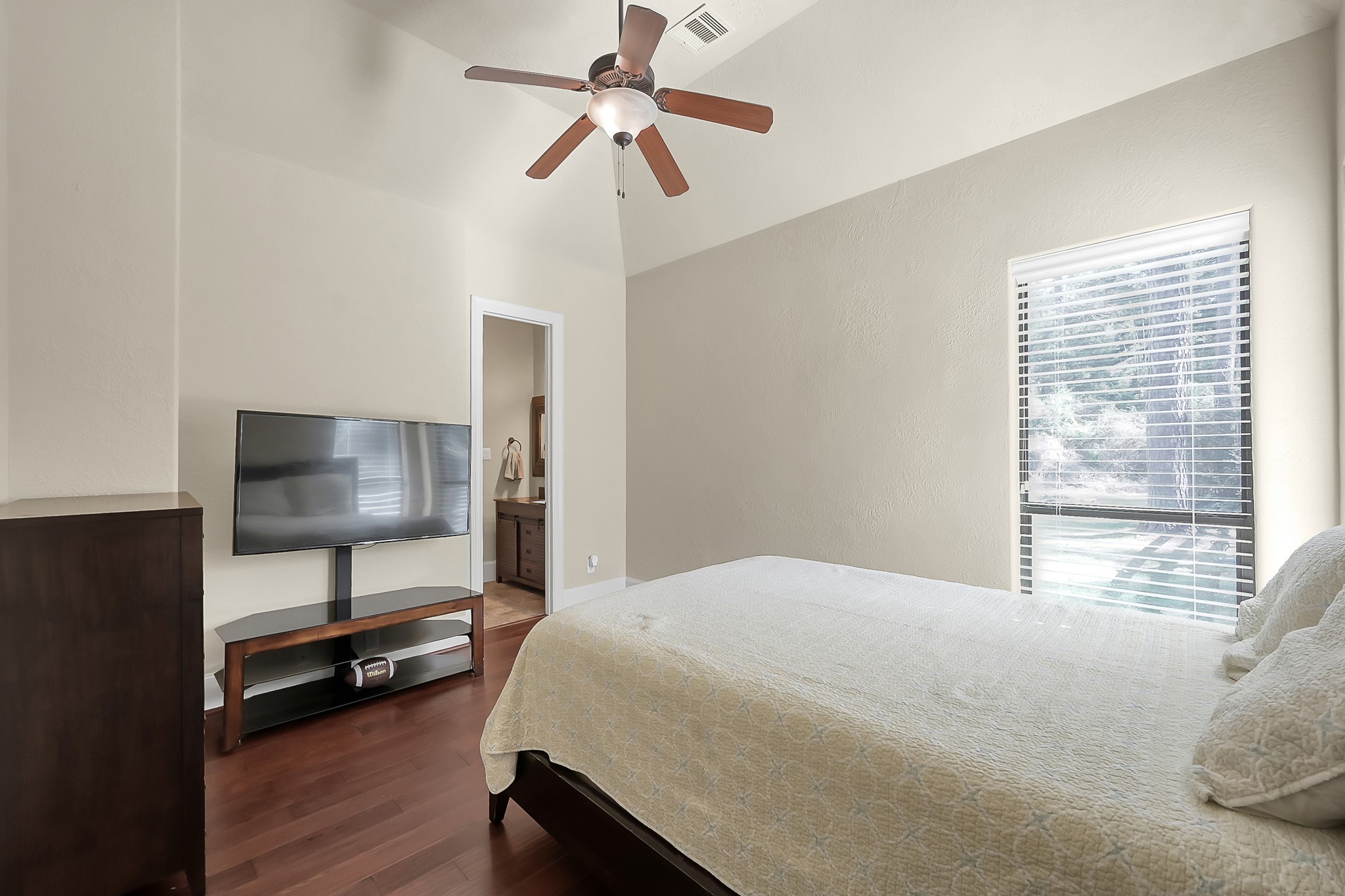 22742 Timberlake Creek Road Tomball, TX 77377 - Photo 32 of 50 a bedroom with a bed and a chandelier