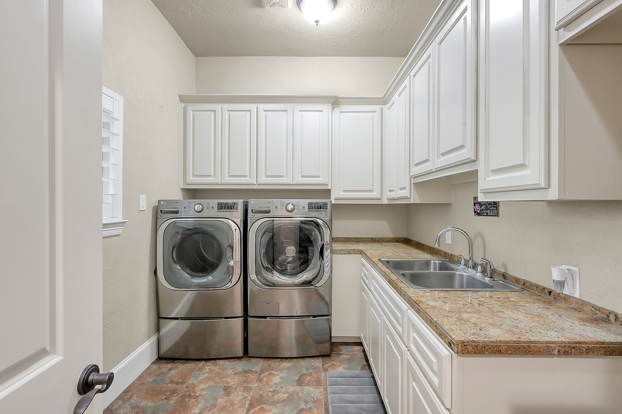 22742 Timberlake Creek Road Tomball, TX 77377 - Photo 37 of 50 a kitchen with a sink a stove and cabinets