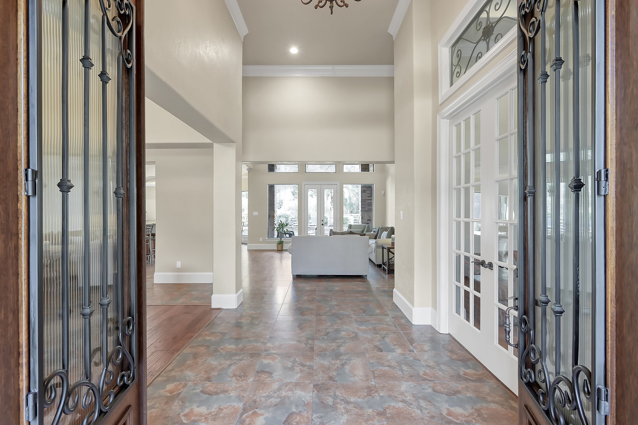22742 Timberlake Creek Road Tomball, TX 77377 - Photo 4 of 50 a view of a hallway with a chandelier and a bathroom