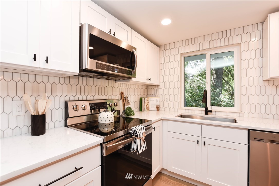 19409 High Rock Road Monroe, WA 98272 - Photo 11 of 40 a kitchen with a sink a stove and microwave