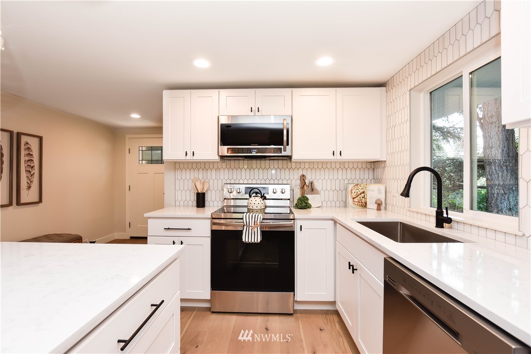 19409 High Rock Road Monroe, WA 98272 - Photo 13 of 40 a kitchen with a sink white cabinets and white appliances