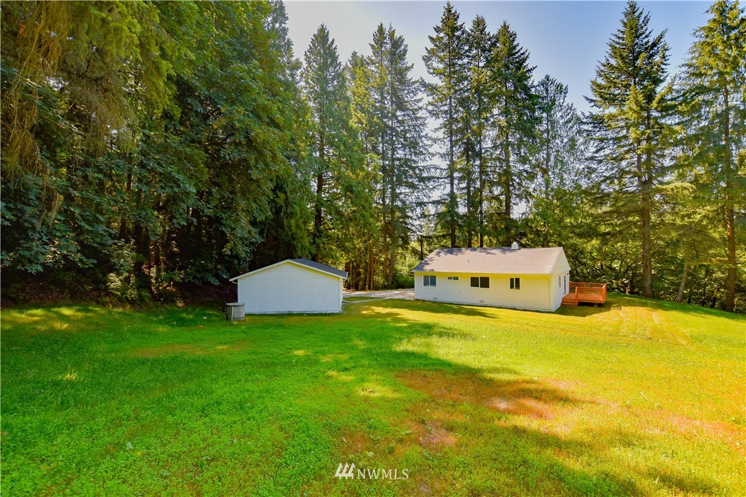 19409 High Rock Road Monroe, WA 98272 - Photo 35 of 40 a view of a swimming pool with a yard and large trees