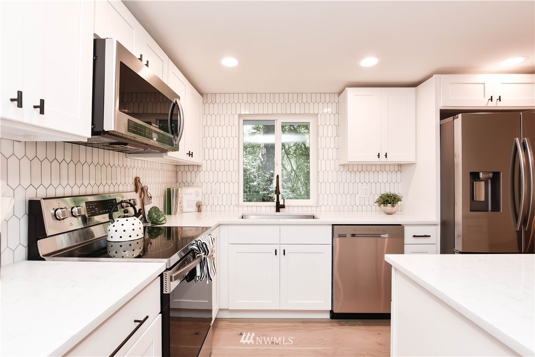 19409 High Rock Road Monroe, WA 98272 - Photo 10 of 40 a kitchen with a sink a stove and a refrigerator