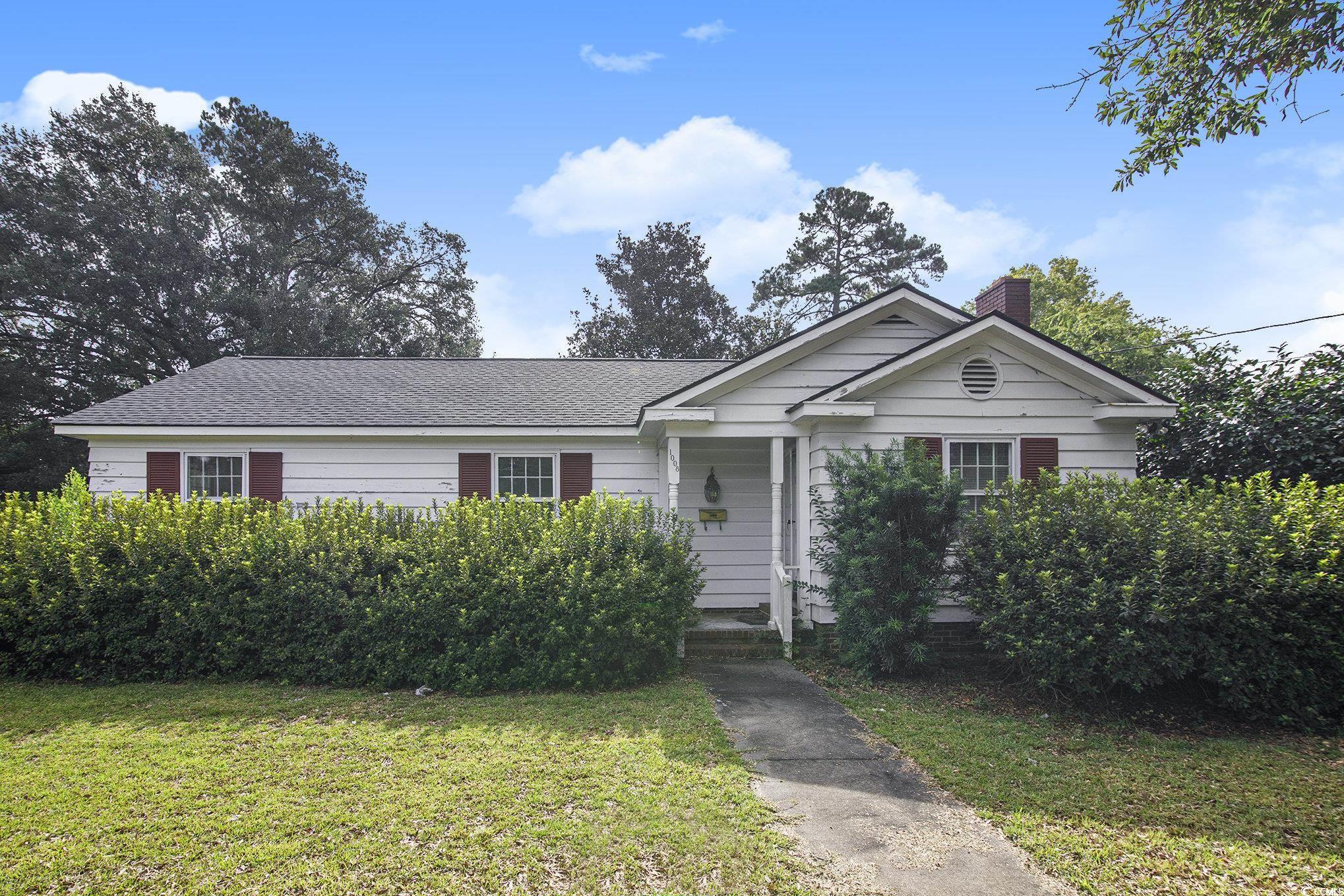 1008 North Main Street Marion, SC 29571 - Photo 1 of 27 View of front of house featuring a front lawn, a chimney, and roof with shingles