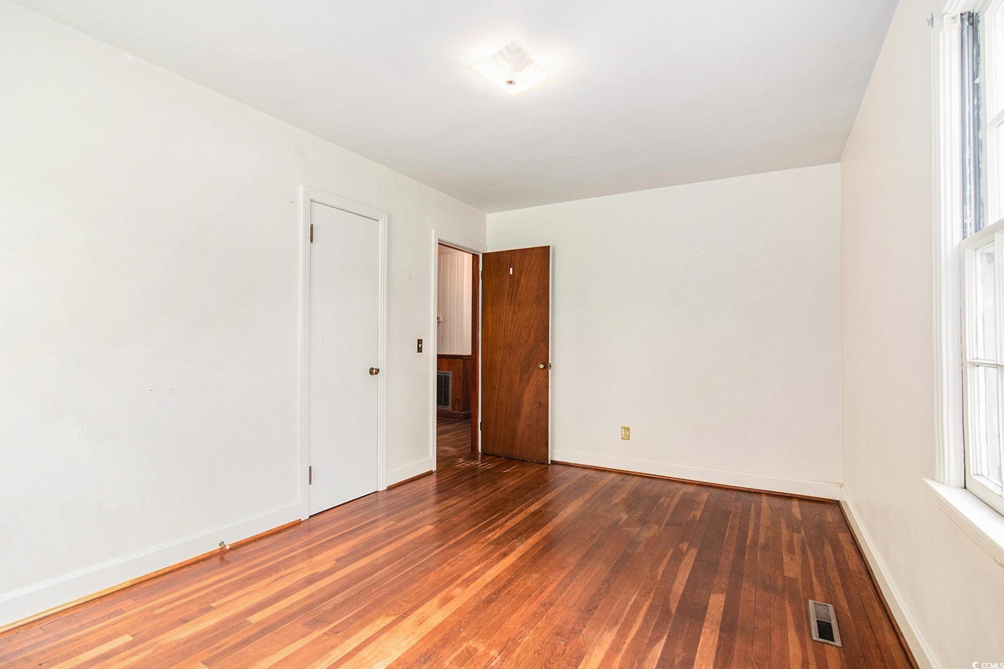 1008 North Main Street Marion, SC 29571 - Photo 13 of 27 Unfurnished room with dark wood-type flooring and baseboards