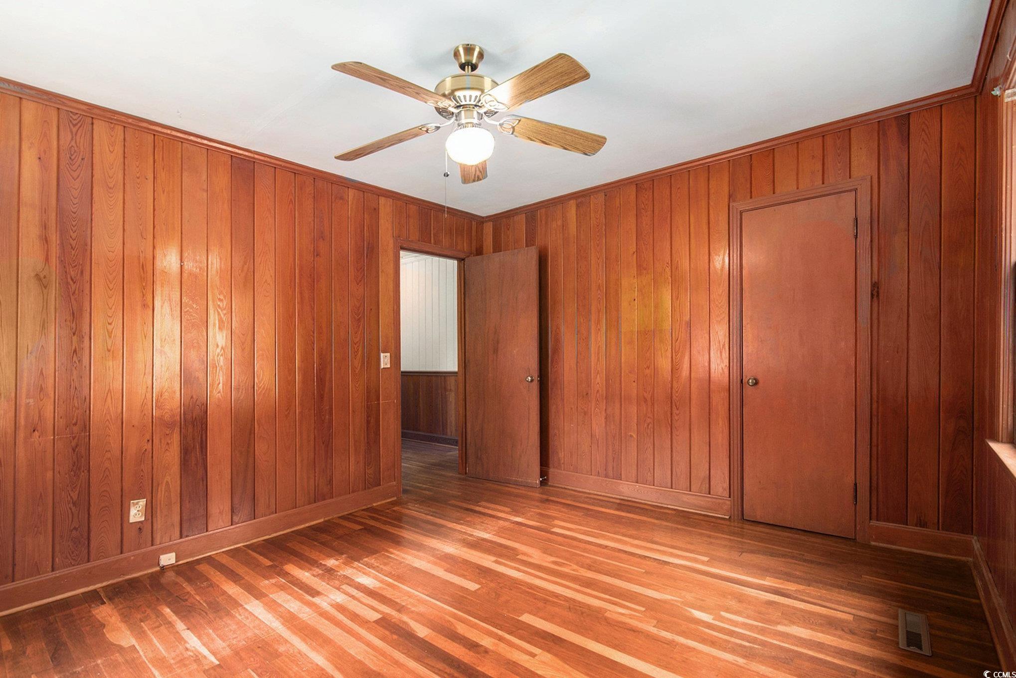 1008 North Main Street Marion, SC 29571 - Photo 22 of 27 Unfurnished bedroom featuring light wood-style flooring, a ceiling fan, and a closet