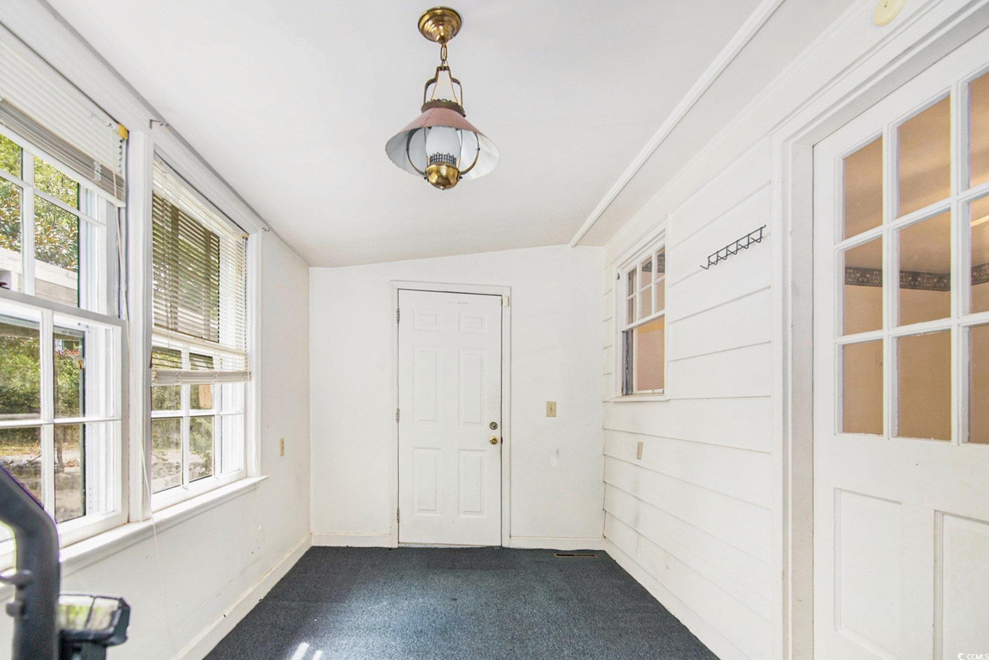 1008 North Main Street Marion, SC 29571 - Photo 24 of 27 Unfurnished sunroom with plenty of natural light and lofted ceiling