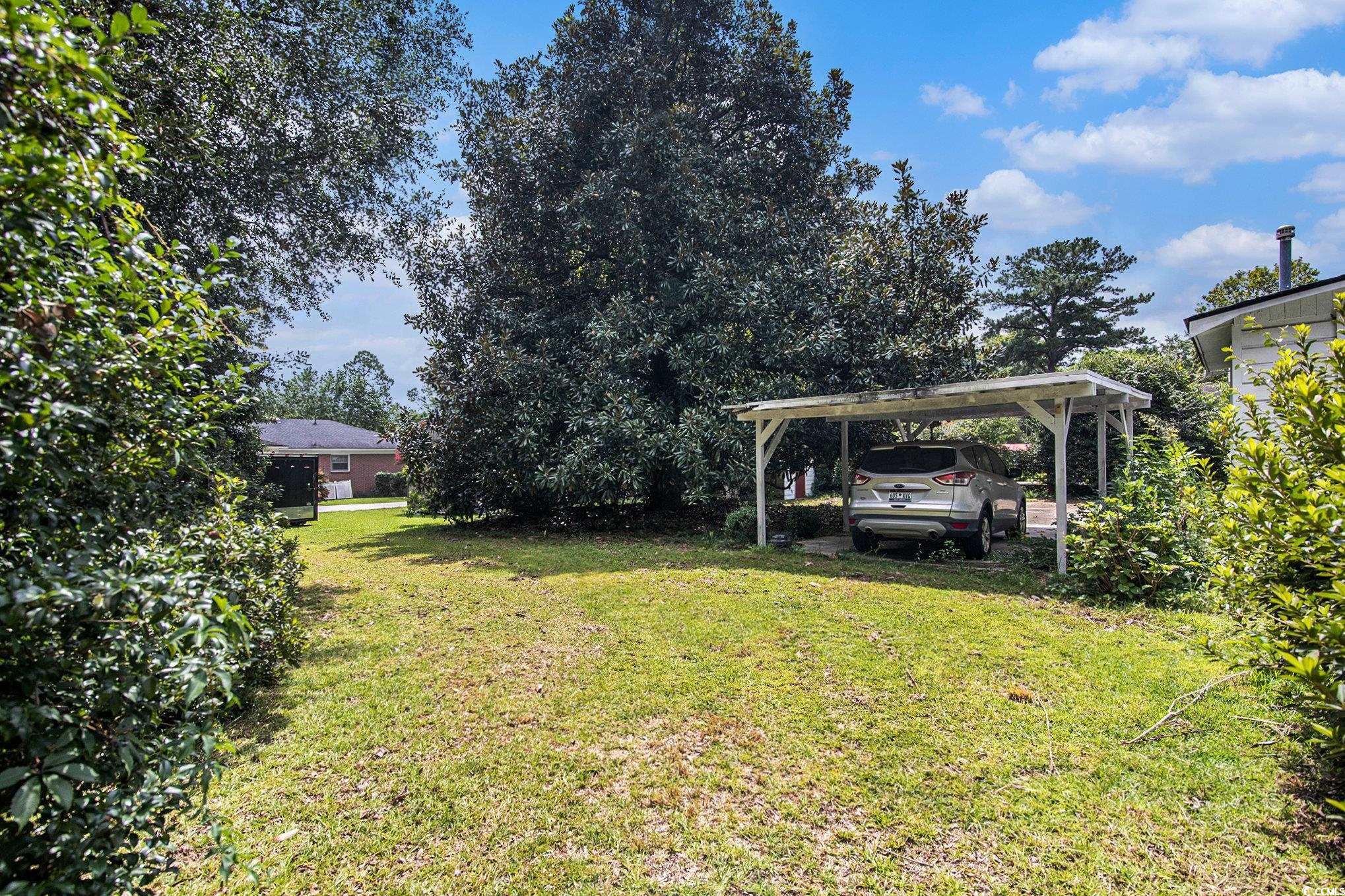 1008 North Main Street Marion, SC 29571 - Photo 27 of 27 View of green lawn featuring a carport