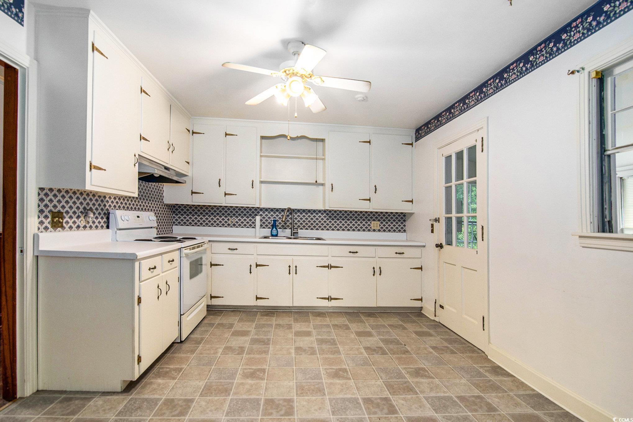 1008 North Main Street Marion, SC 29571 - Photo 10 of 27 Kitchen featuring light countertops, backsplash, white electric range, and open shelves