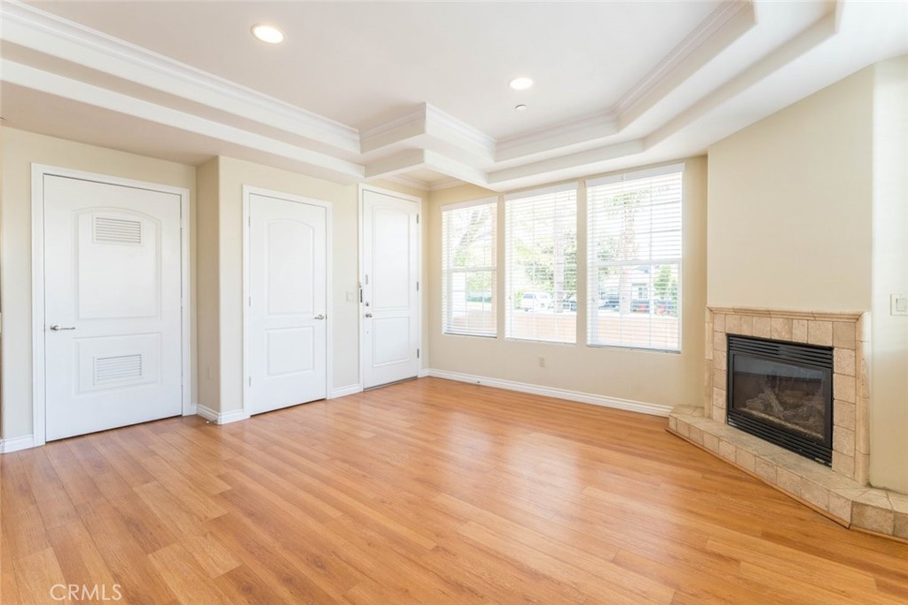 511 East Harvard Road, Unit 101 Burbank, CA 91501 - Photo 6 of 29 a view of empty room with wooden floor and fireplace