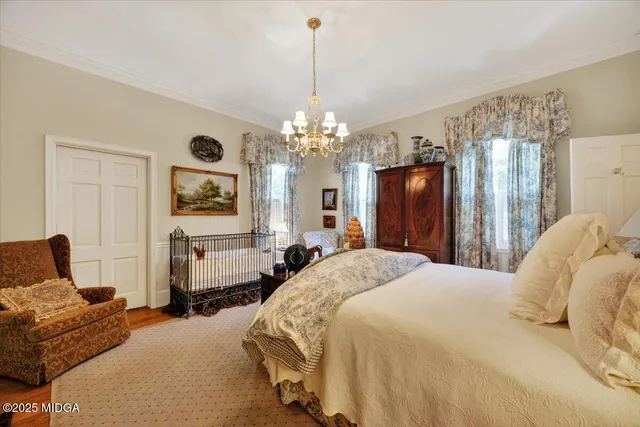 a living room with furniture a chandelier and a fireplace