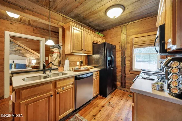 an aerial view of residential houses with outdoor space and trees