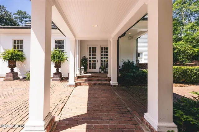 a view of a porch with furniture and wooden floor