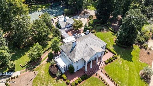 a view of a hallway with wooden floor and furniture