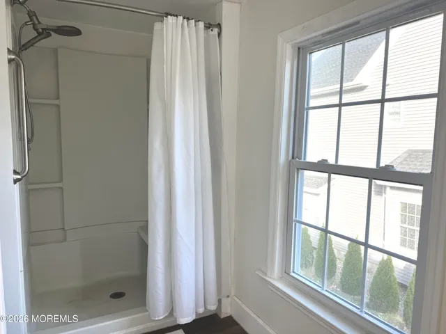 a bathroom with a glass shower door