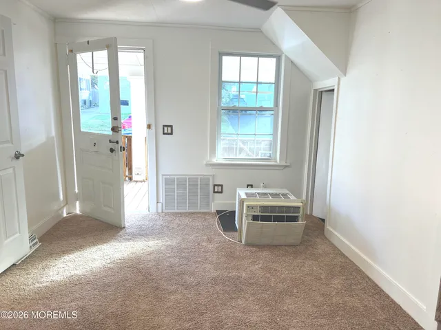 a view of a livingroom with furniture window and front door