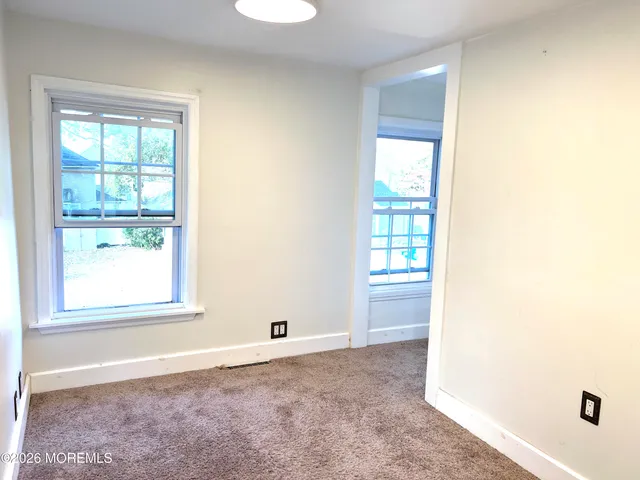 a view of an empty room and a window