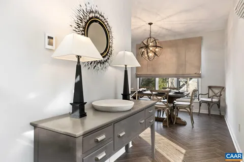 a view of a dining room with furniture wooden floor and chandelier