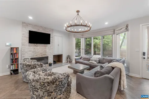 a living room with furniture a fireplace and a flat screen tv