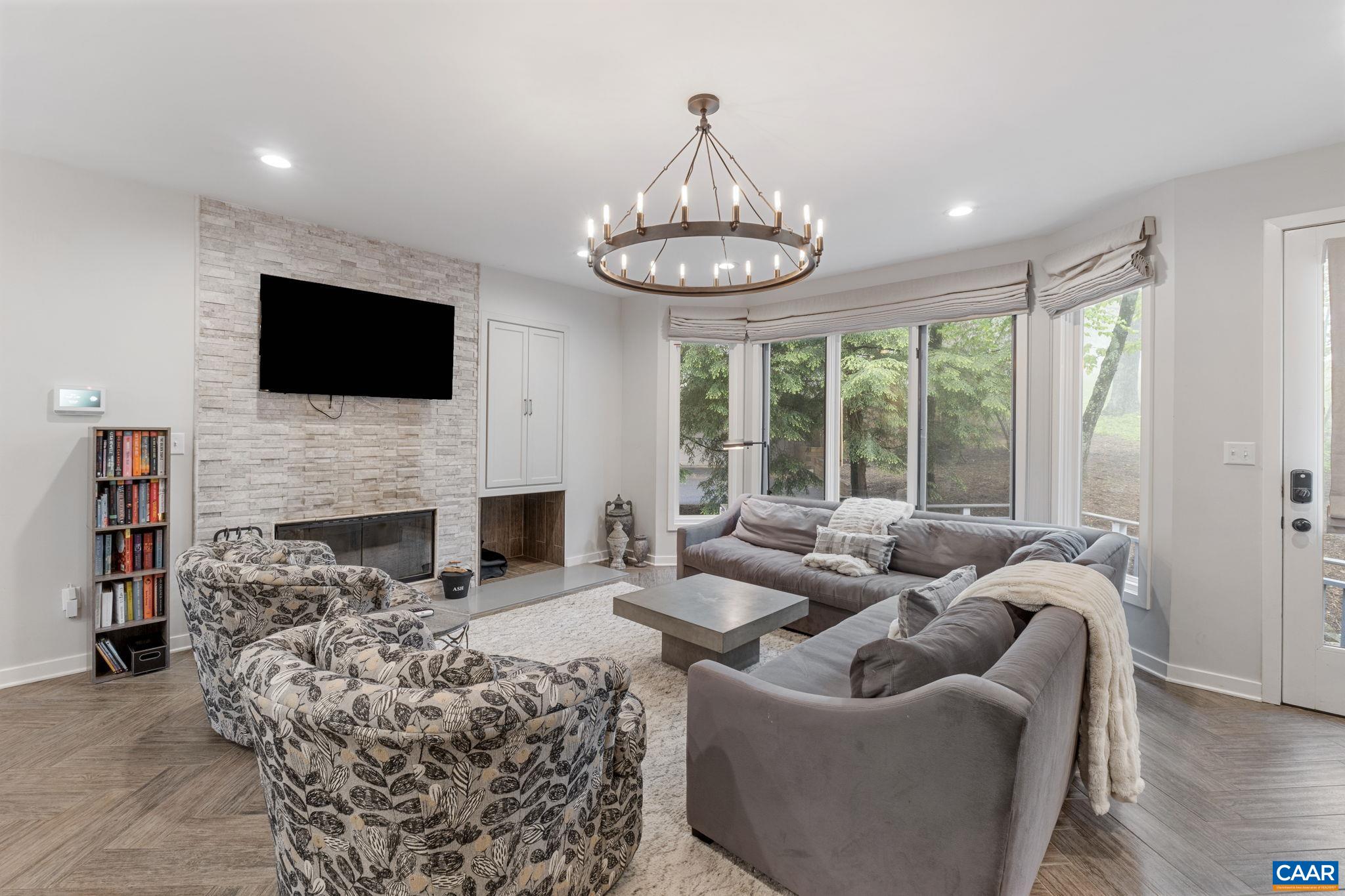 23 Trillium Cl Roseland, VA 22967 - Photo 2 of 48 a living room with furniture a fireplace and a flat screen tv