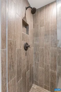 a bathroom with a shower and a sink