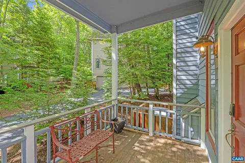 a view of a porch with a floor to ceiling window and an outdoor view
