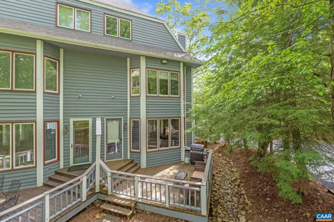 a view of a house with backyard and porch