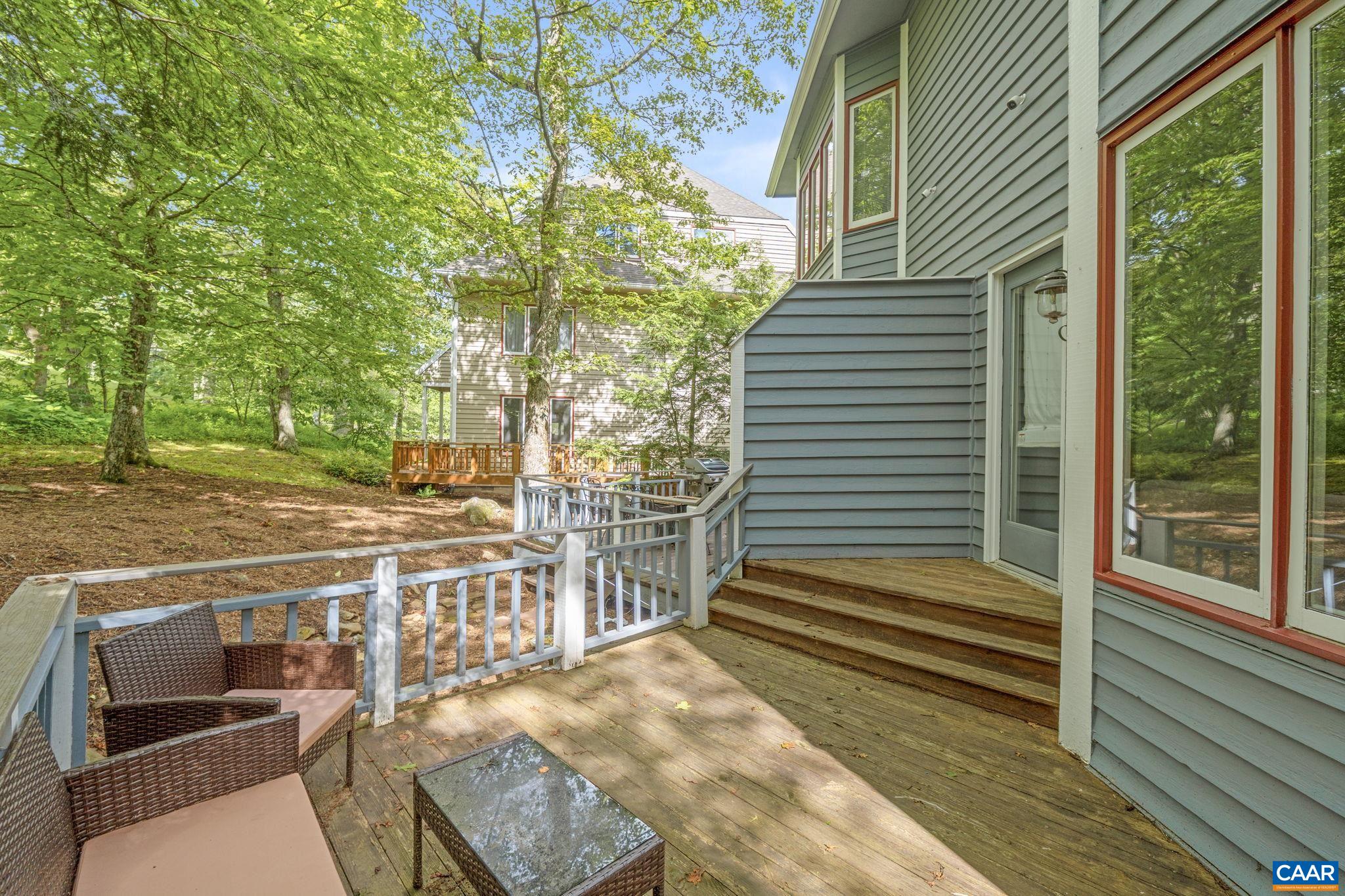 23 Trillium Cl Roseland, VA 22967 - Photo 43 of 48 a view of a patio with table and chairs with wooden floor and fence