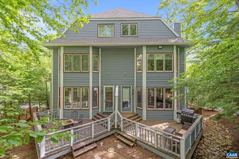 a view of house with a chairs and table in a patio