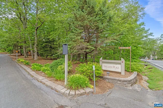 a pathway of a house with a yard and fence