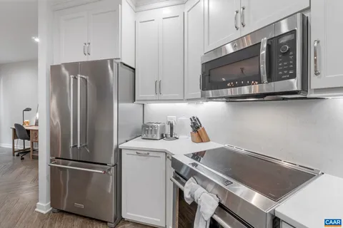 a kitchen with a refrigerator sink and cabinets