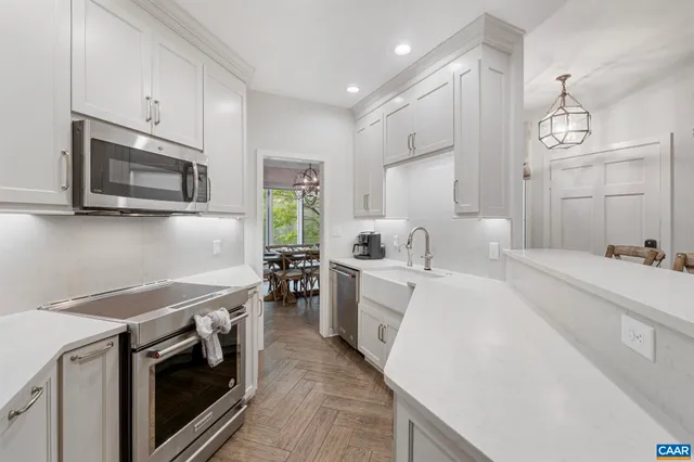 a kitchen with a sink stove and microwave