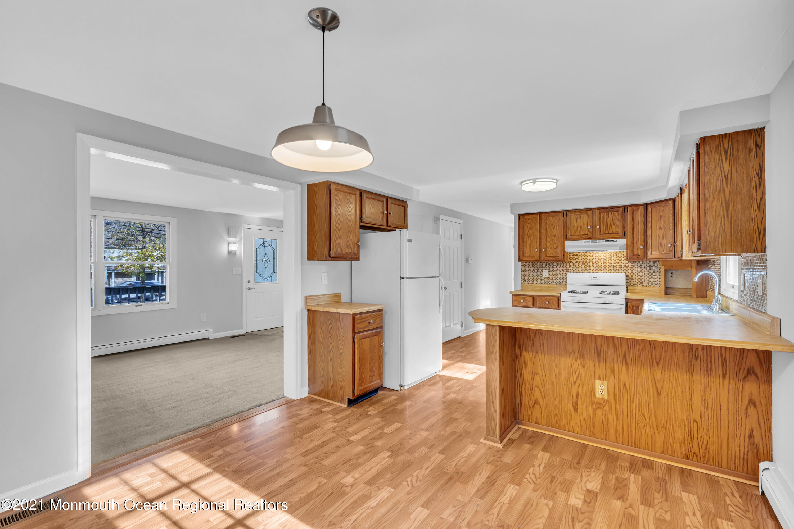 11 Tennent Road Morganville, NJ 07751 - Photo 11 of 20 a view of a kitchen with a sink and a refrigerator