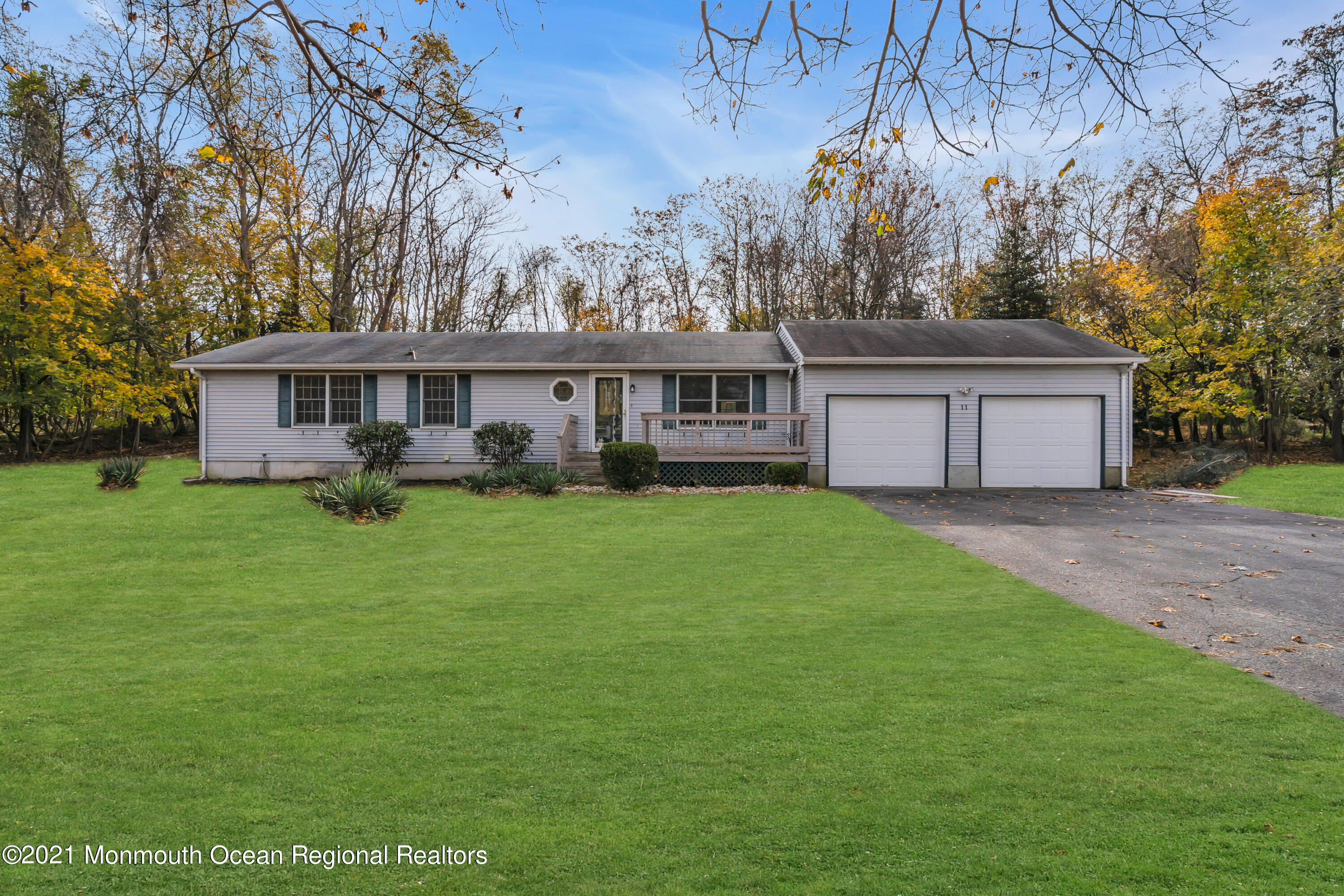 11 Tennent Road Morganville, NJ 07751 - Photo 20 of 20 a front view of a house with a garden and trees