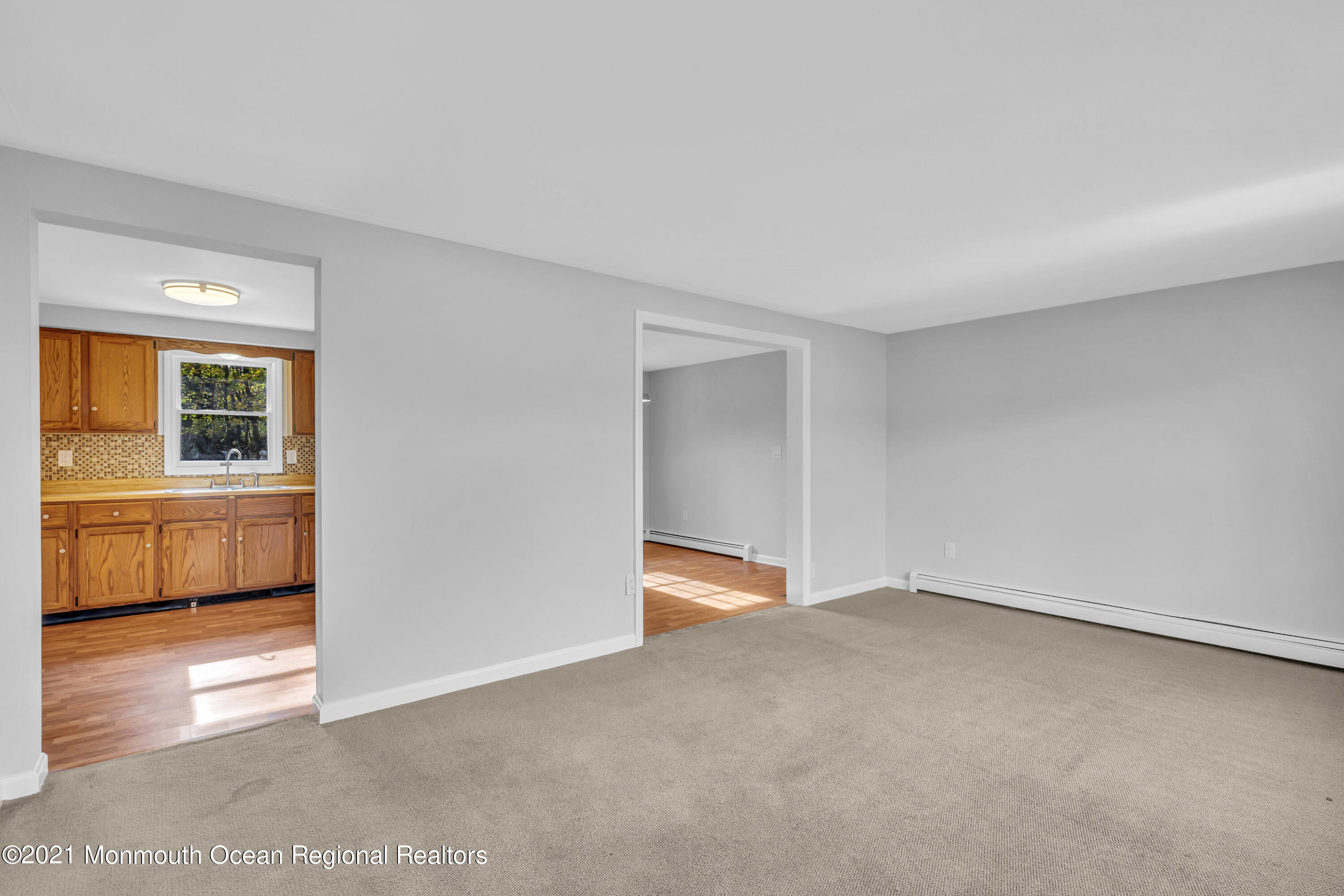 11 Tennent Road Morganville, NJ 07751 - Photo 3 of 20 a view of an empty room and a kitchen