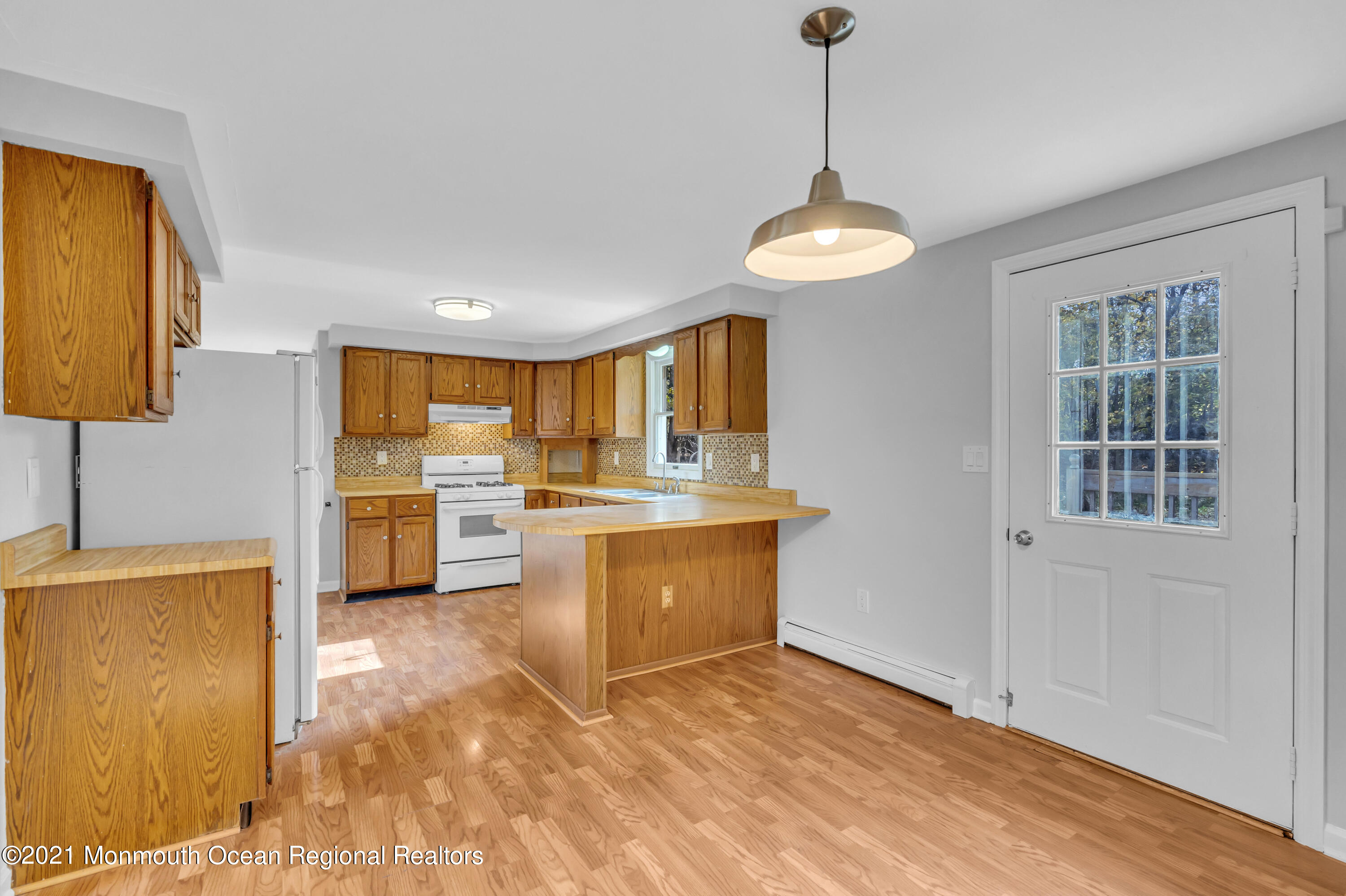 11 Tennent Road Morganville, NJ 07751 - Photo 10 of 20 a view of a kitchen with a sink dishwasher and wooden floor