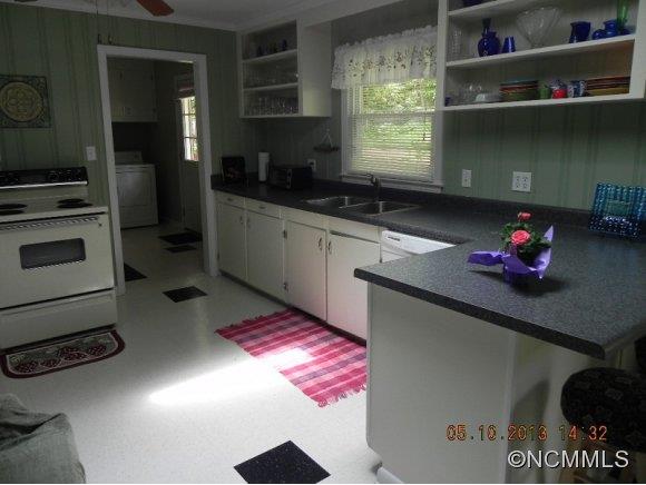 331 Edwards Street Rutherfordton, NC 28139 - Photo 4 of 20 a kitchen with a refrigerator and a stove