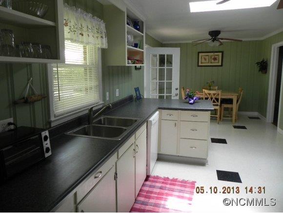 331 Edwards Street Rutherfordton, NC 28139 - Photo 5 of 20 a kitchen with granite countertop a sink a stove and cabinets
